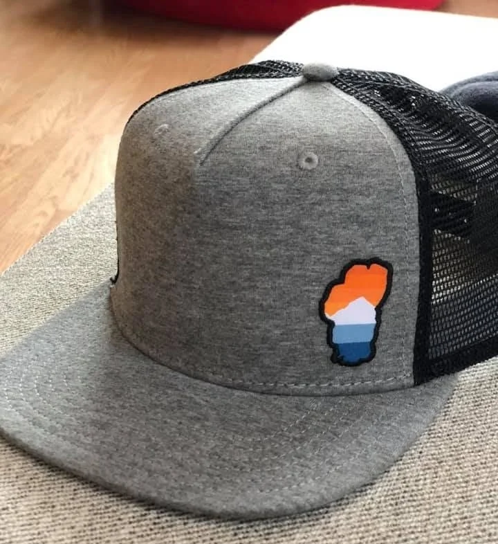 Gray outdoor cap with a colorful landscape patch